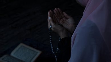 Muslim Women is praying in mosque raising hands for dua