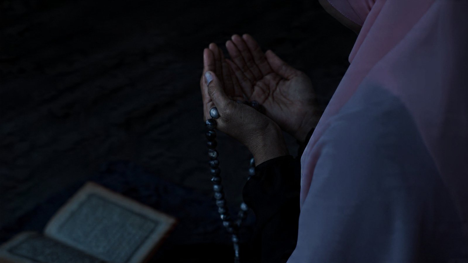 Muslim Women is praying in mosque raising hands for dua